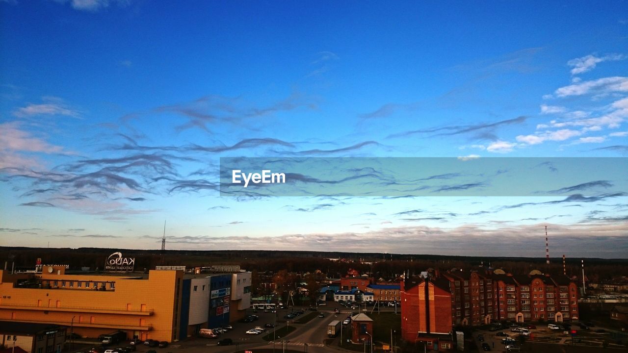 VIEW OF CITYSCAPE AGAINST BLUE SKY