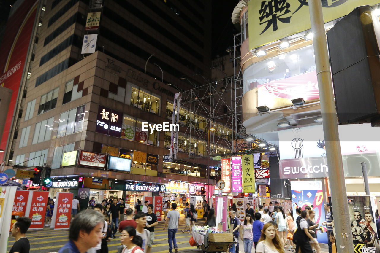 CROWD IN ILLUMINATED CITY