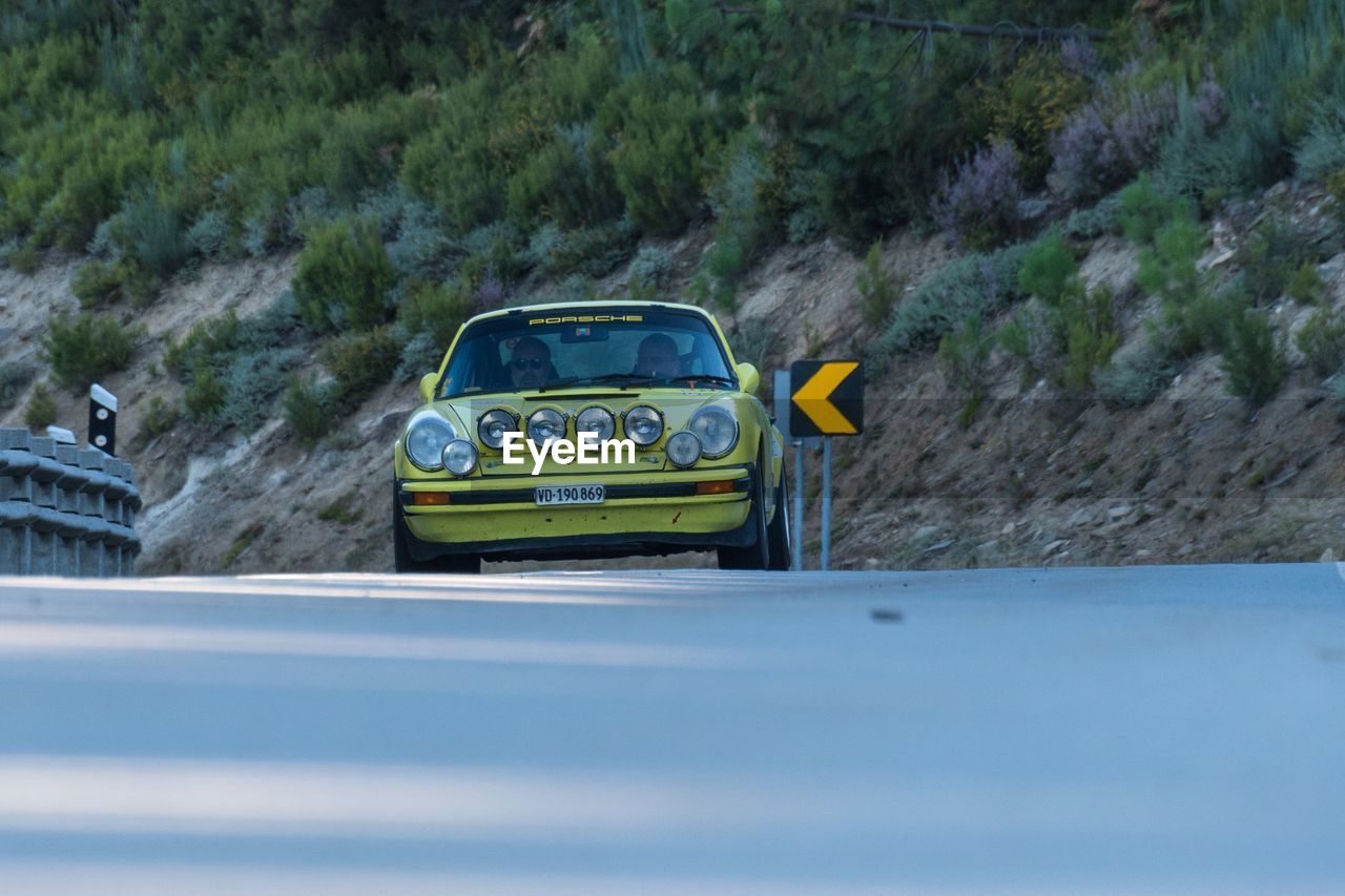 YELLOW CAR ON ROAD