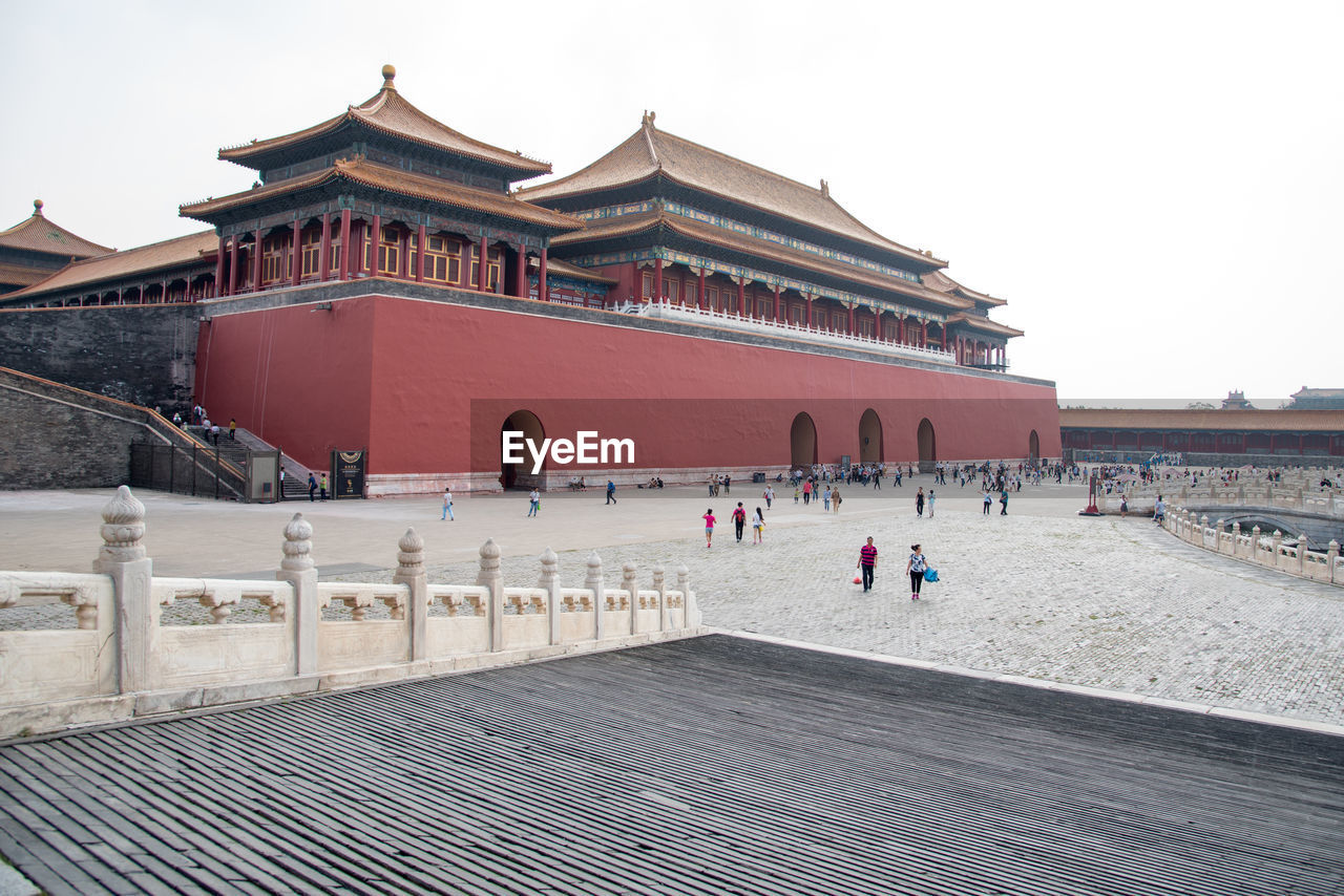 PEOPLE IN FRONT OF BUILT STRUCTURE