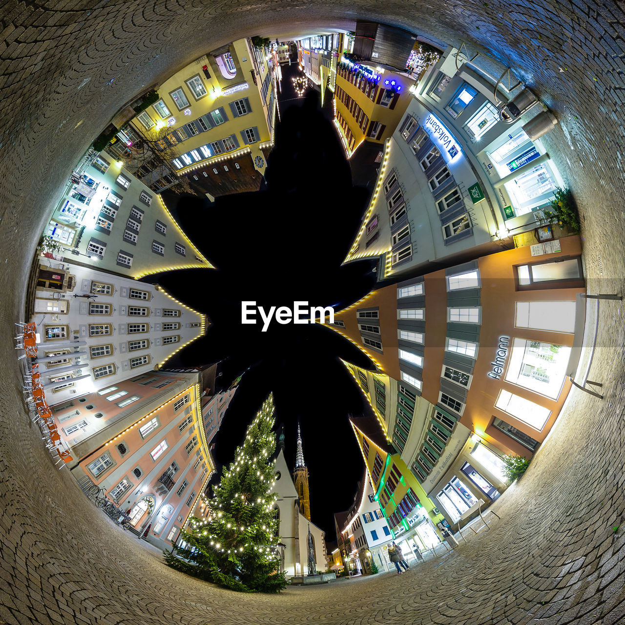 MIDSECTION OF WOMAN IN ILLUMINATED CITY
