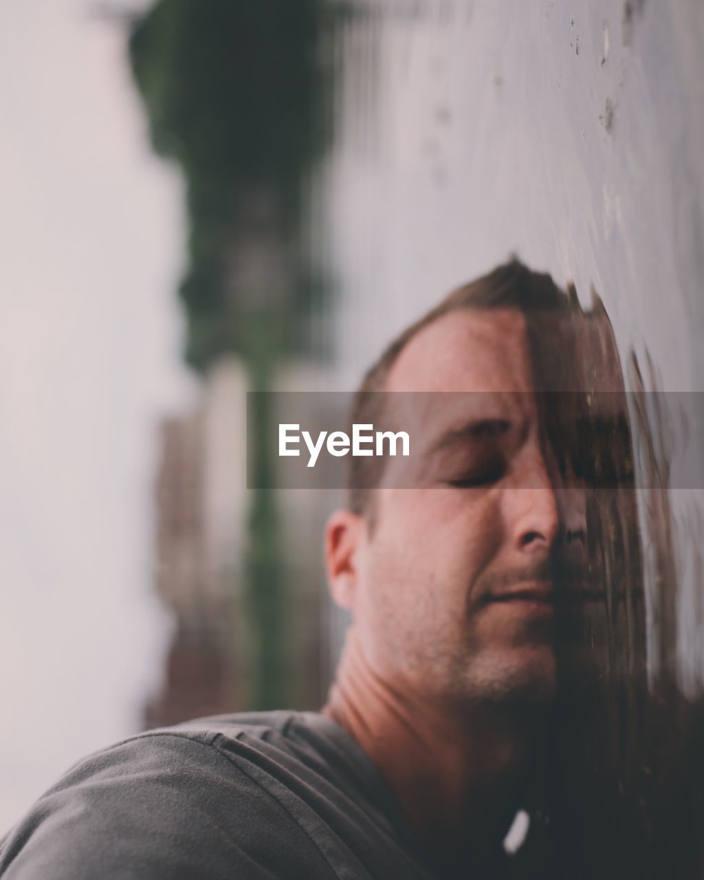 Close-up of man with closed eyes in lake