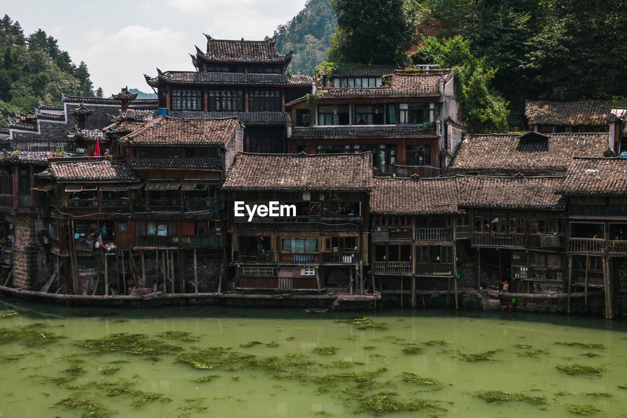 houses by lake against sky