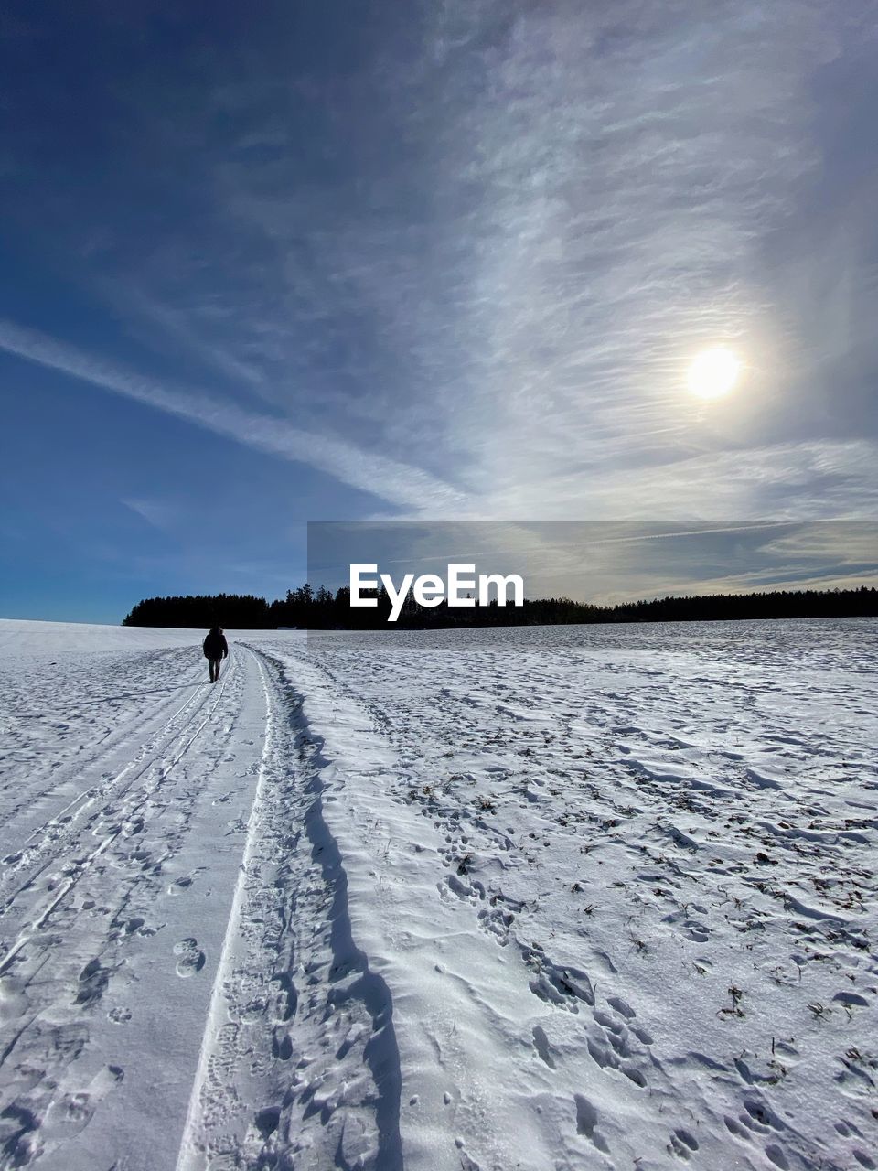 SNOW COVERED FIELD AGAINST SKY