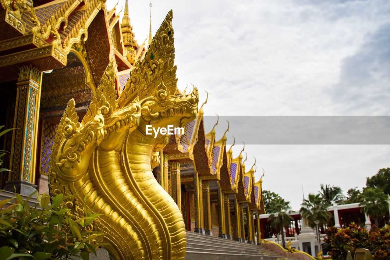 Statue of temple in building against sky