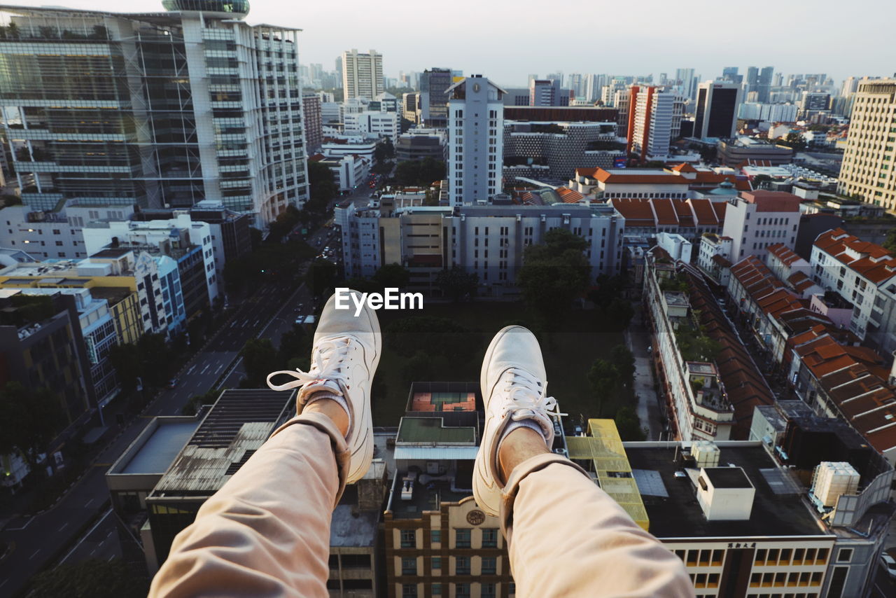 Low section of man and buildings in city