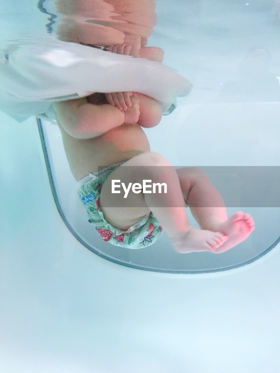 Low section of baby in bathtub