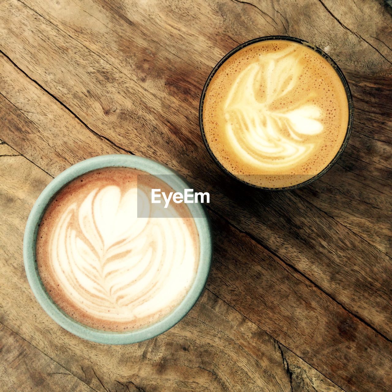 High angle view of cappuccinos served on table