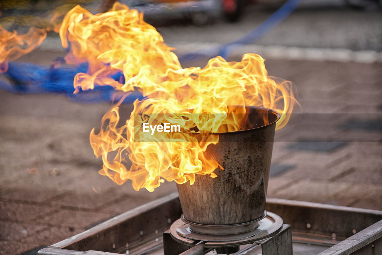 CLOSE-UP OF FIRE BURNING ON METAL