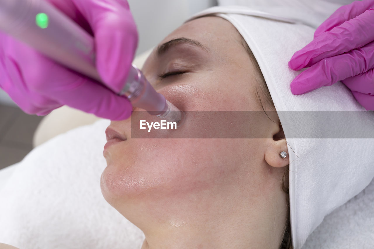 body care, healthcare and medicine, adult, human face, skin, beauty spa, women, spa treatment, beauty treatment, wellbeing, health spa, relaxation, indoors, skin care, medicine, lying down, patient, doctor, two people, care, eyes closed, female, person, hygiene, headshot, nose, surgical glove, occupation, young adult, protective glove, close-up, hospital, human head, human skin, professional occupation, portrait, surgery, facial mask - beauty product, medical clinic, lifestyles, applying, healthcare worker, hand, human eye, body care and beauty, lip, protective workwear, exfoliation, pink, beauty product, towel, alternative therapy, spa, eyebrow, illness, nurse, massaging, baby, protection, expertise