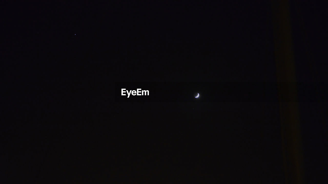 LOW ANGLE VIEW OF MOON AT NIGHT