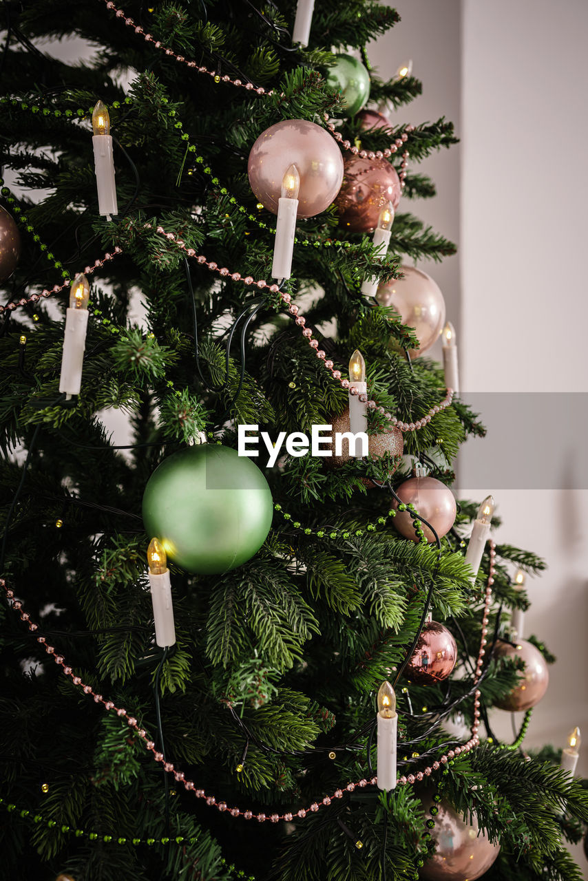 Decorated christmas tree on blurred background.