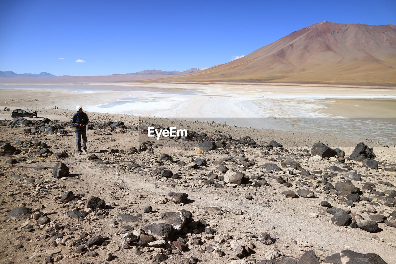 Man standing on land against sky