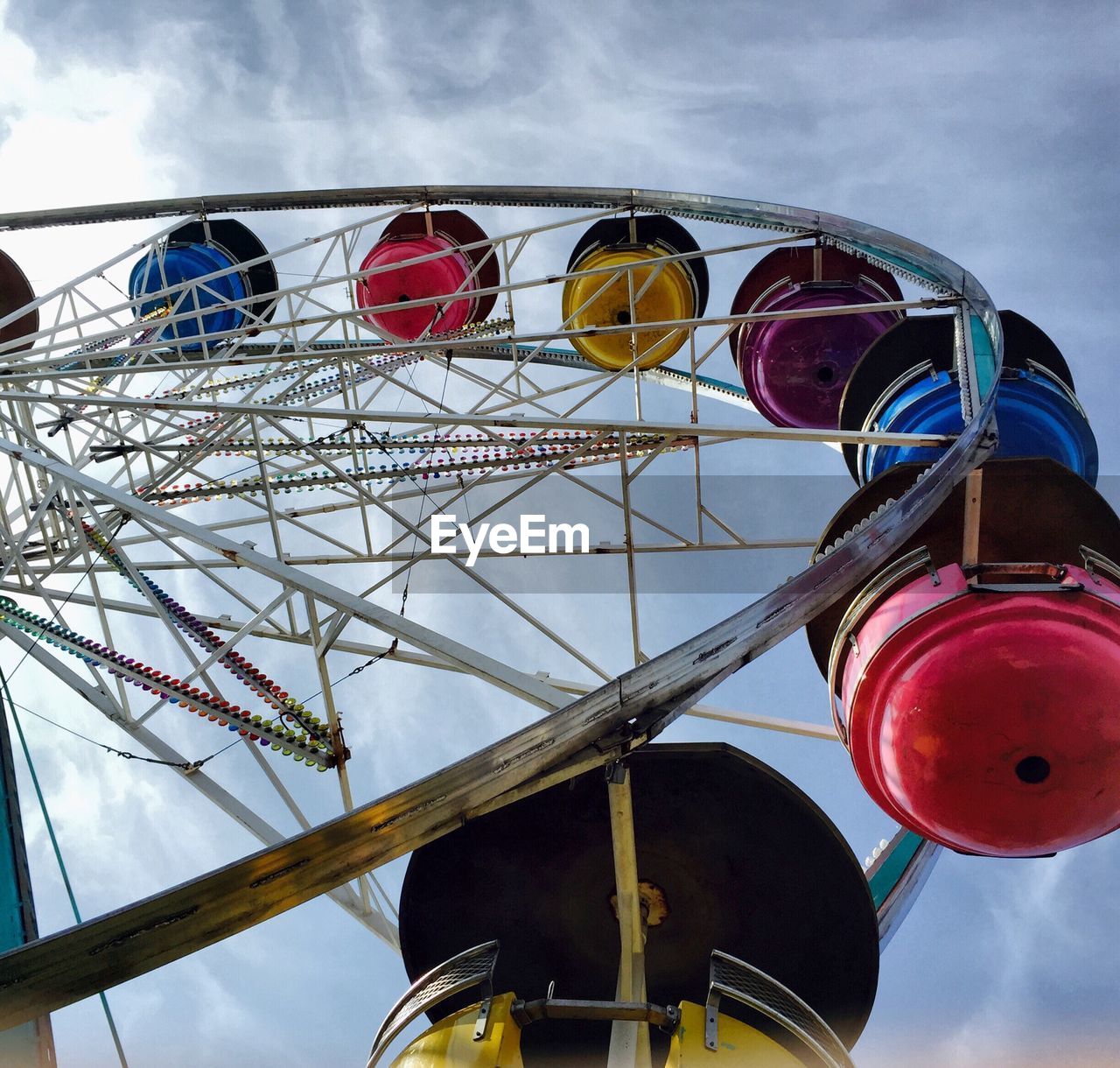 Low angle view of cropped ferris wheel against sky