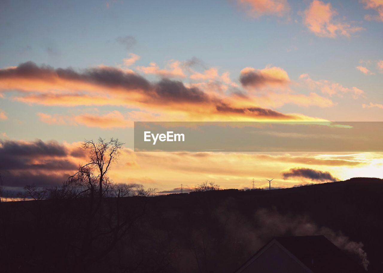 SILHOUETTE TREES AND BUILDINGS AGAINST SKY DURING SUNSET