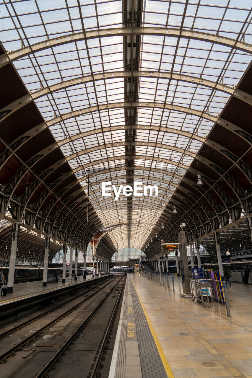 Inside large london train station glass and steel roof