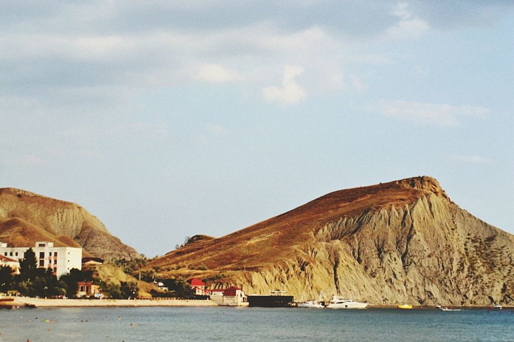 SCENIC VIEW OF SEA WITH MOUNTAINS IN BACKGROUND