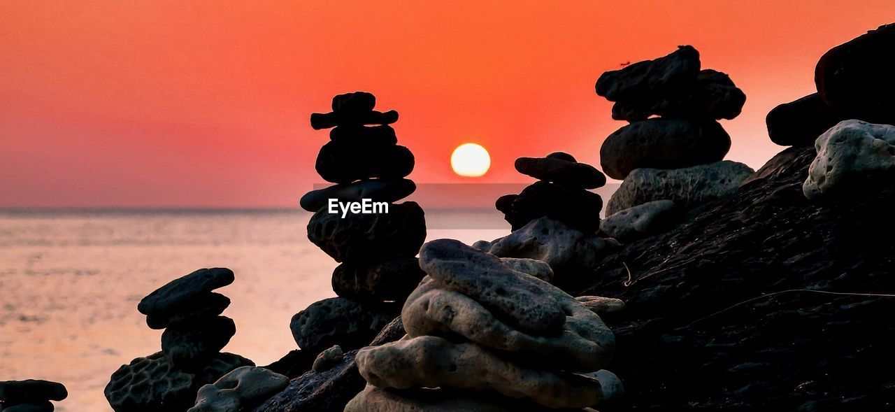 sea, sky, no people, solid, rock, water, sunset, horizon over water, nature, stack, tranquility, beach, balance, rock - object, scenics - nature, beauty in nature, close-up, zen-like, horizon, outdoors, pebble