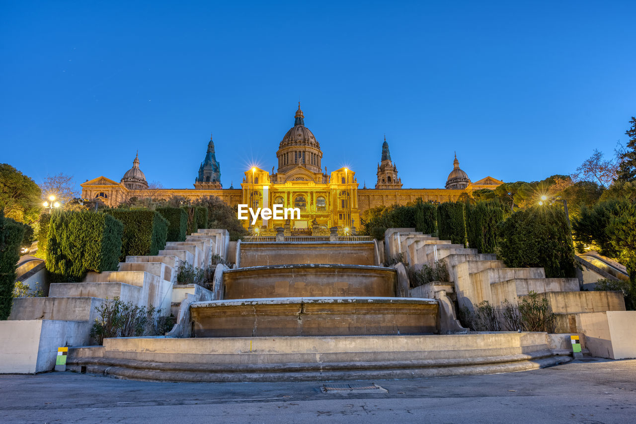 The national palace on montjuic mountain in barcelona illuminated at dawn