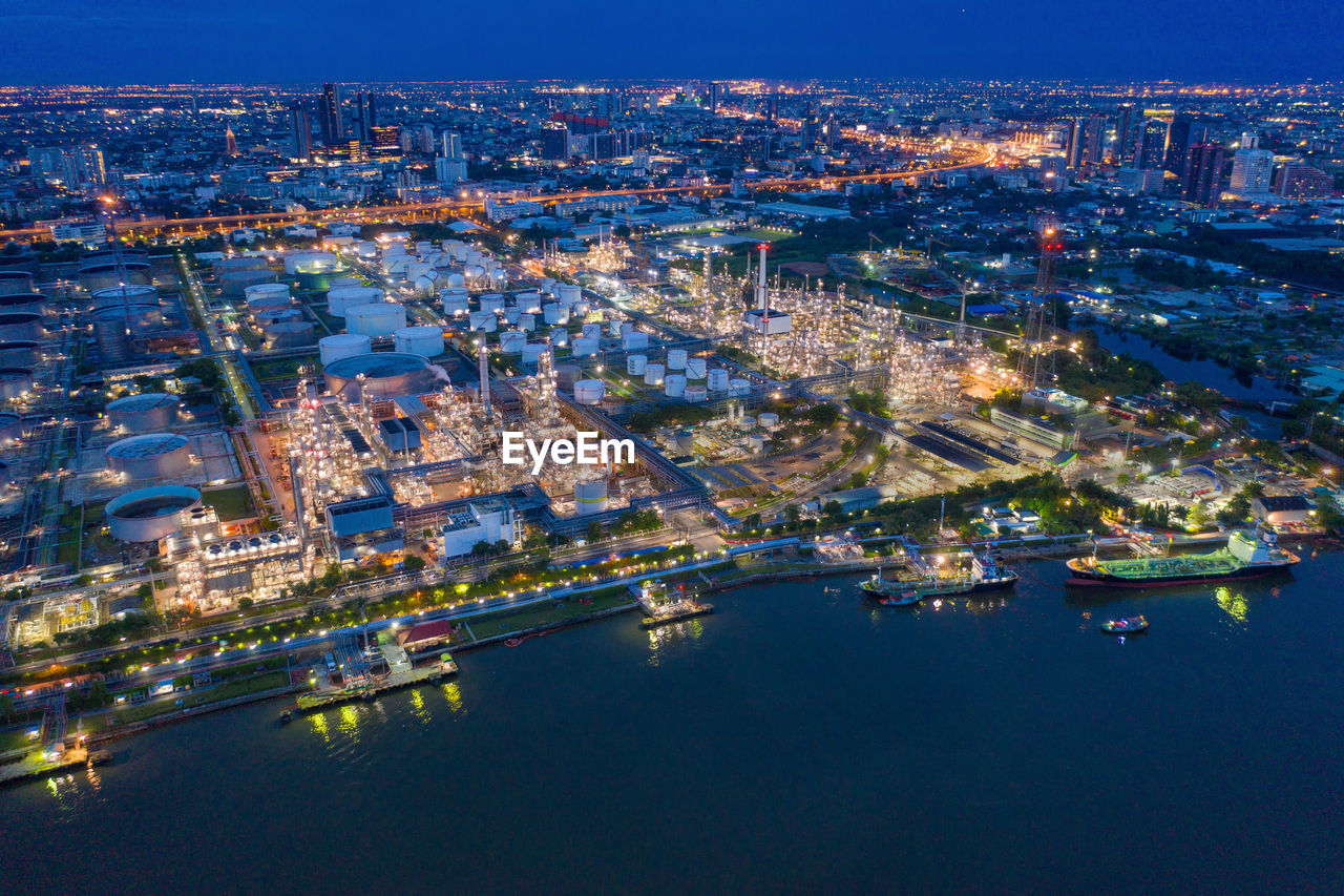 High angle view of city lit up at night