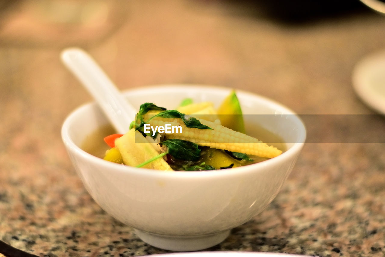 Close-up of baby corn soup on table