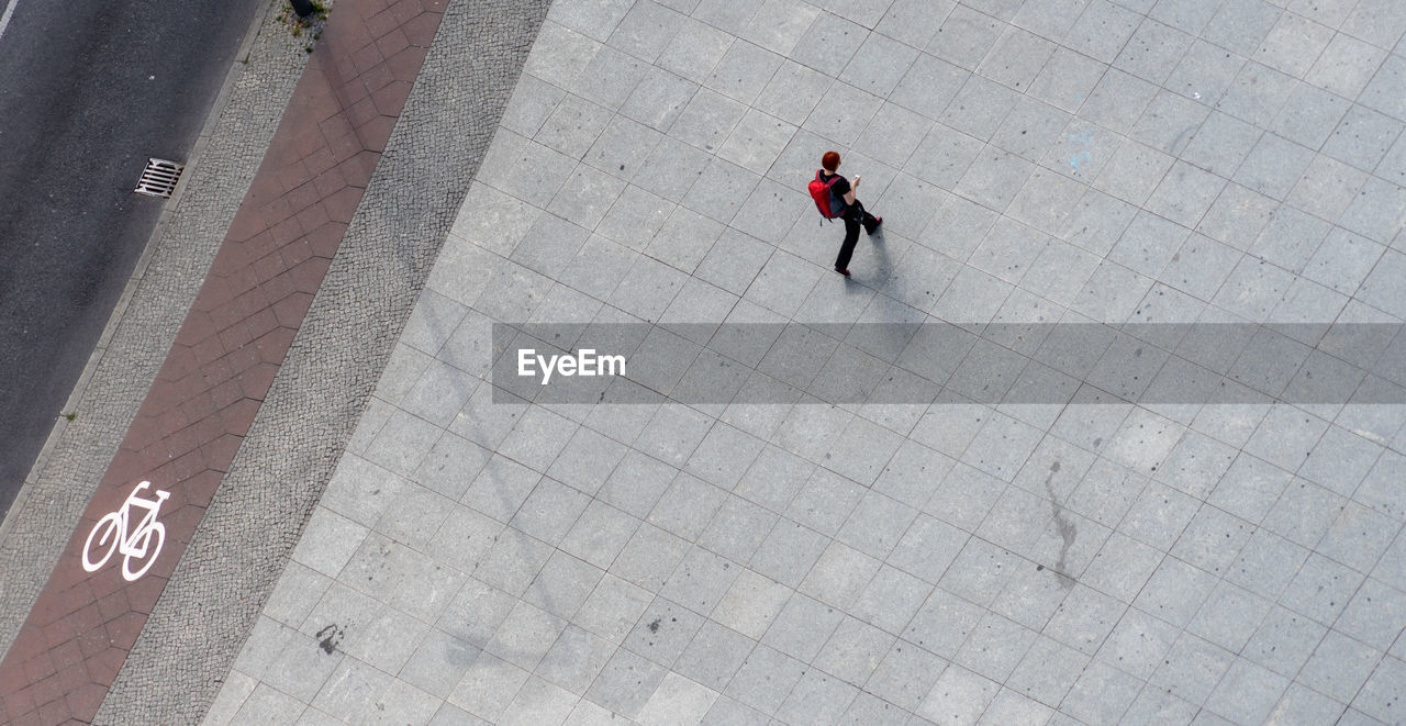 High angle view of woman walking on footpath