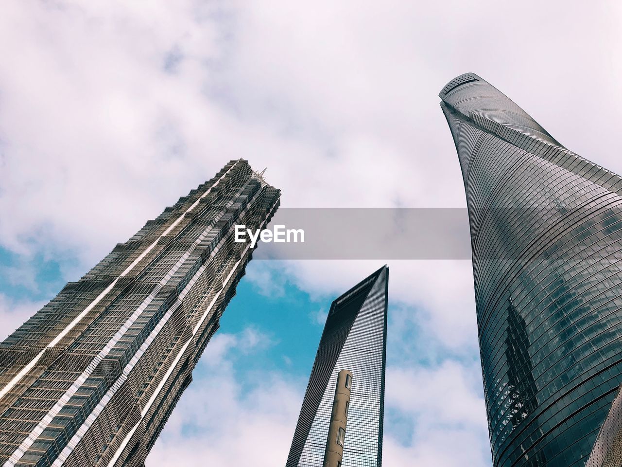 Low angle view of buildings against cloudy sky