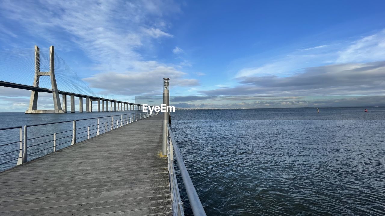 VIEW OF BRIDGE OVER SEA AGAINST SKY