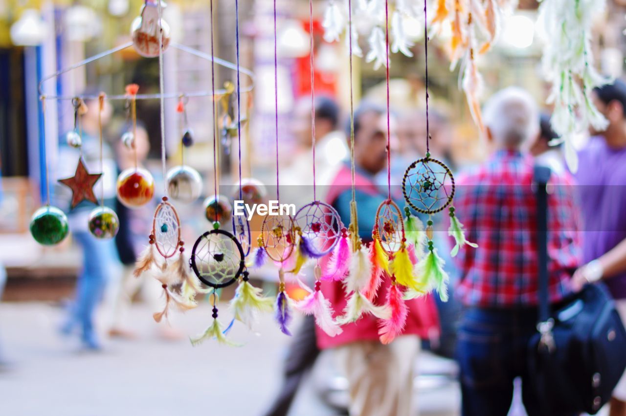 Close-up of multi colored dreamcatcher hanging outdoors