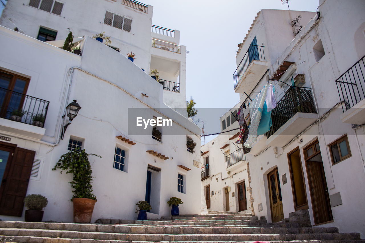 Low angle view of steps amidst residential buildings