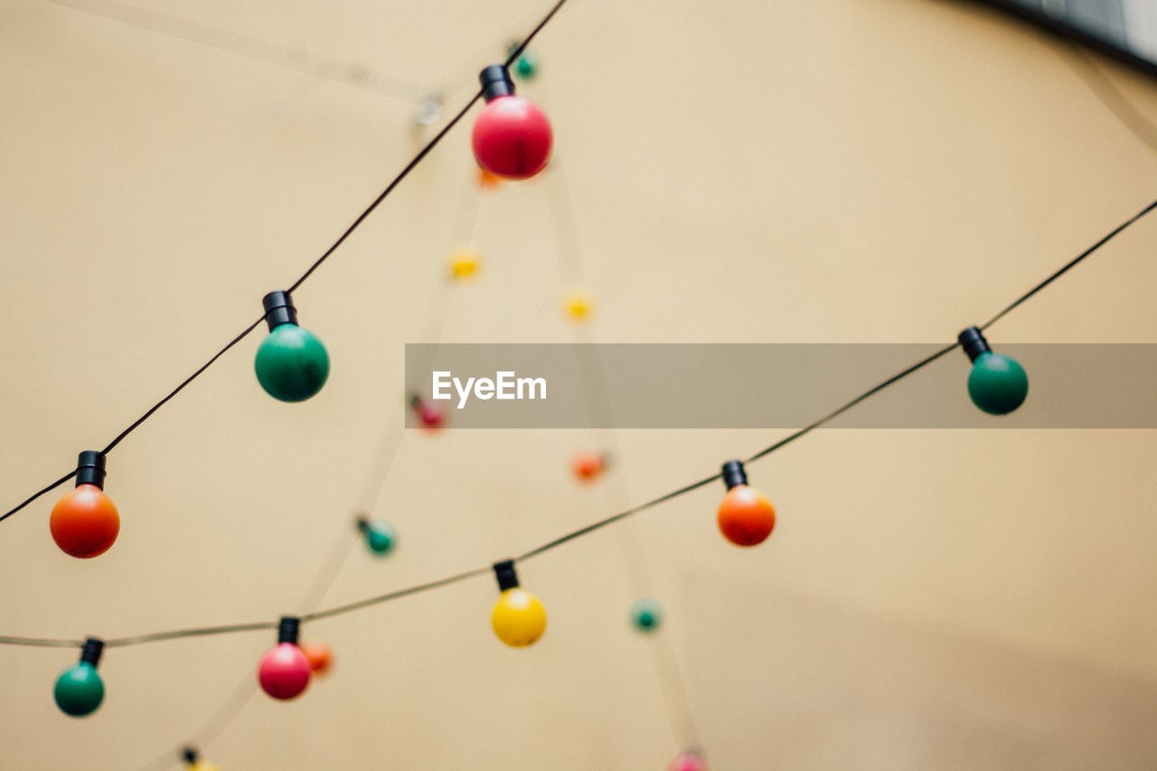 Low angle view of string lights hanging outdoors