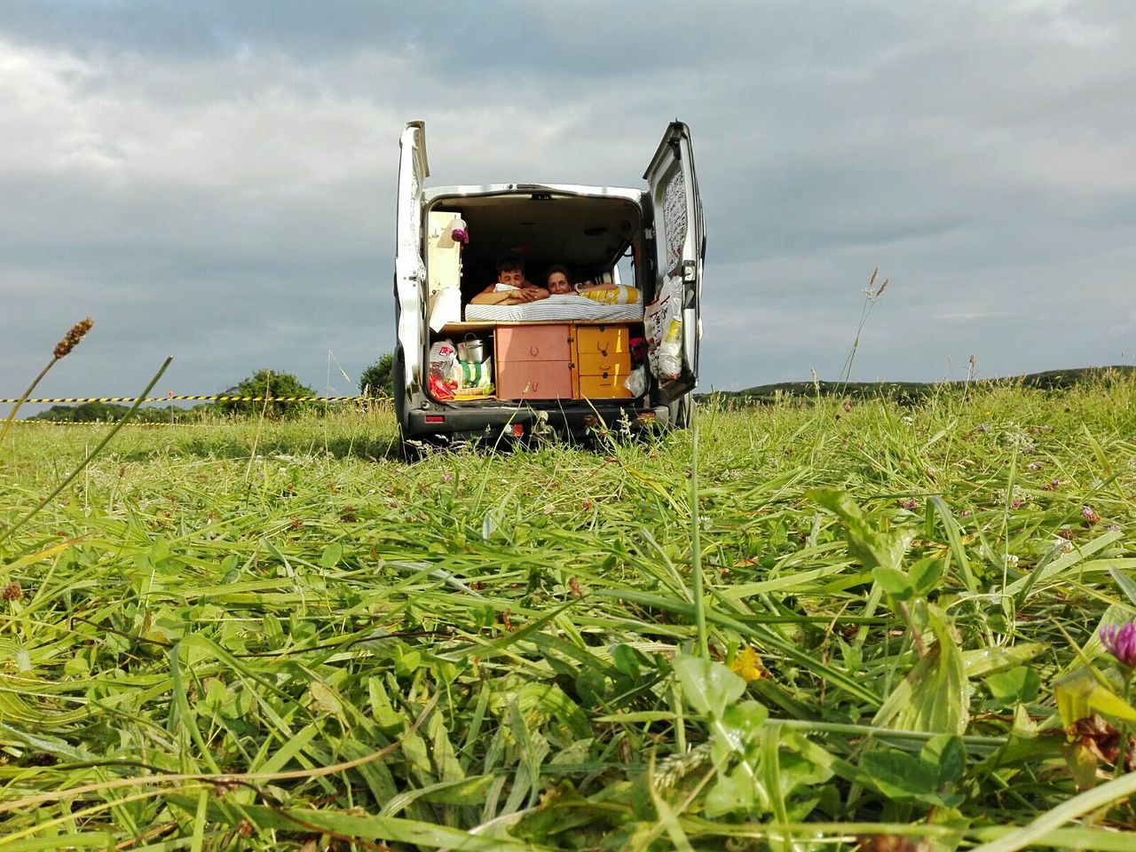 Tractor on agricultural field against sky