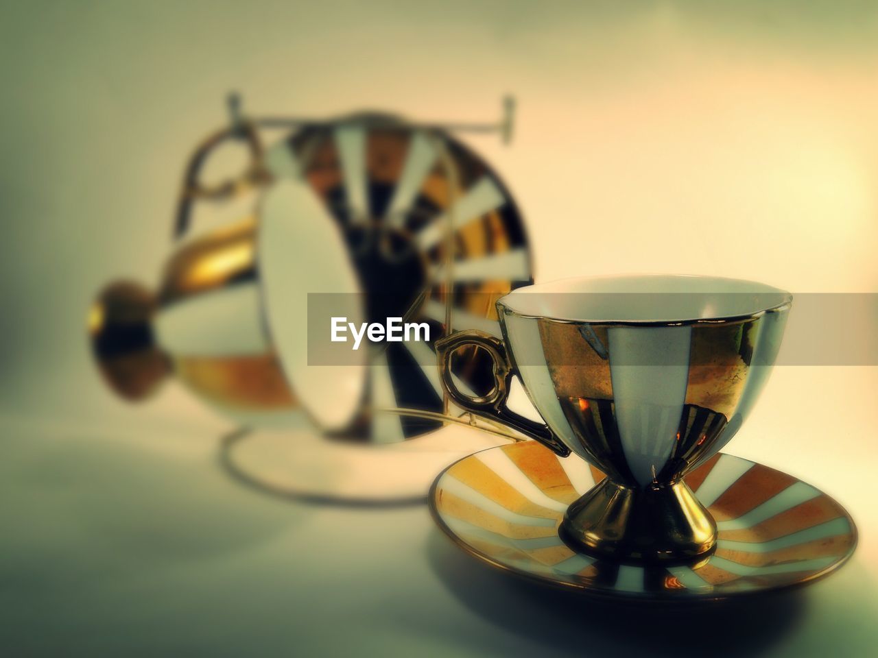 Close up of coffee cup with saucer on table
