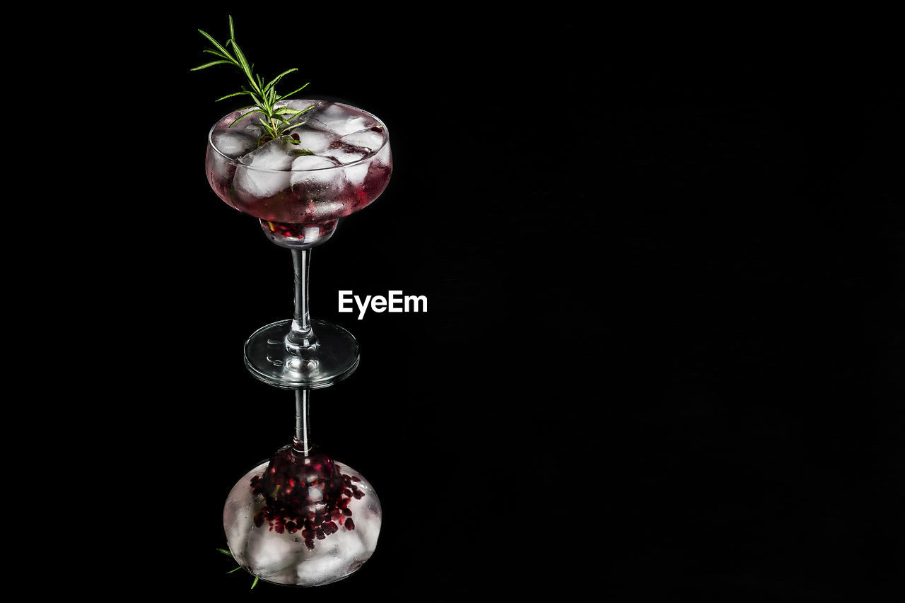 CLOSE-UP OF WINE AGAINST GLASS
