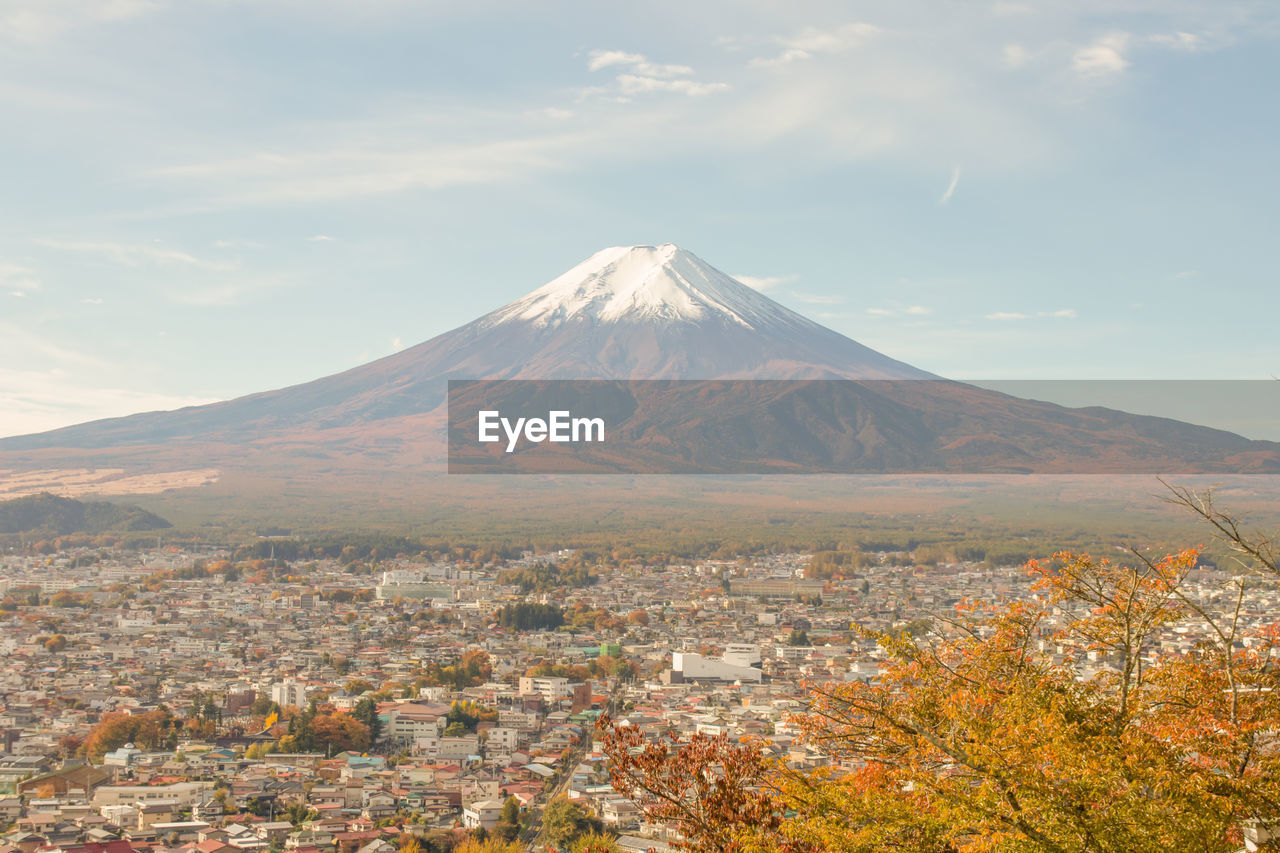 Scenic view of snowcapped fuji mountains against sky at japan.