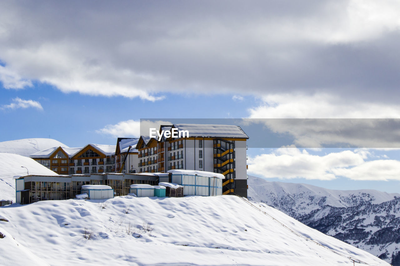 Ski resort, snowy mountains and hostels.