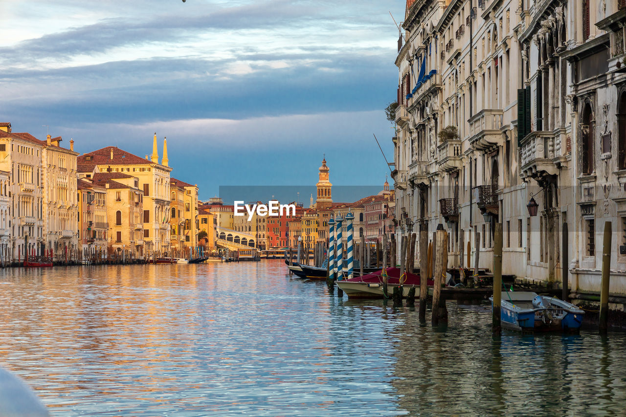 View of canal amidst buildings in city