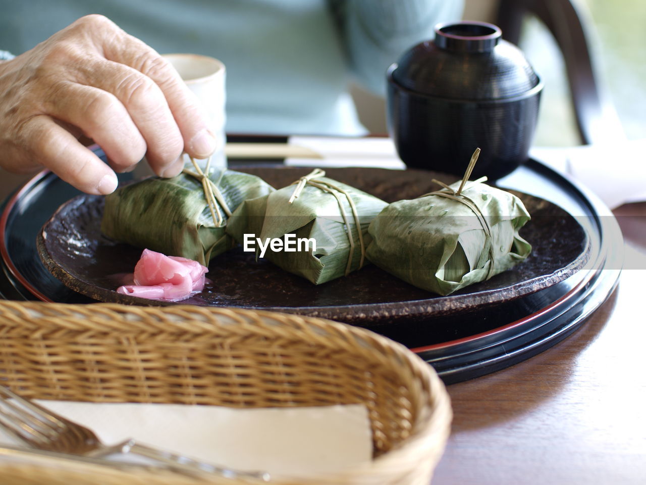 Close-up of human hand holding food on table