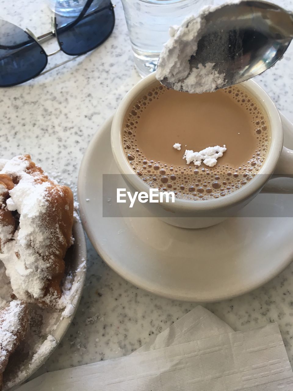 CLOSE-UP OF COFFEE WITH CUP OF CAPPUCCINO