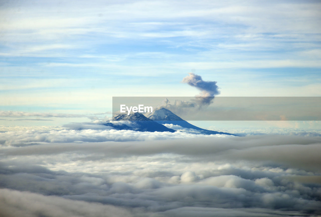 Scenic view of volcanoes amidst cloudscape