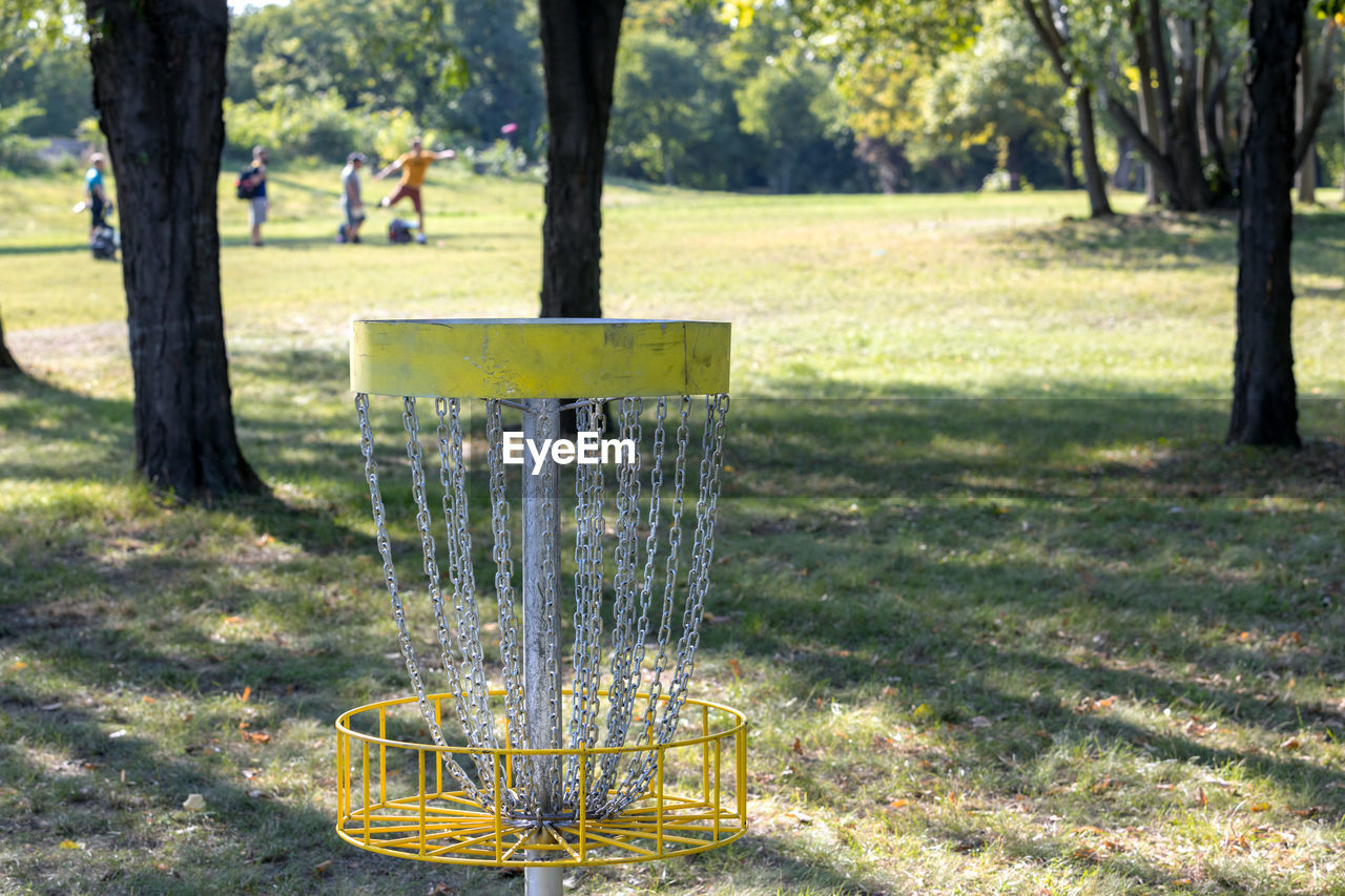 People playing flying disc golf sport game in the park