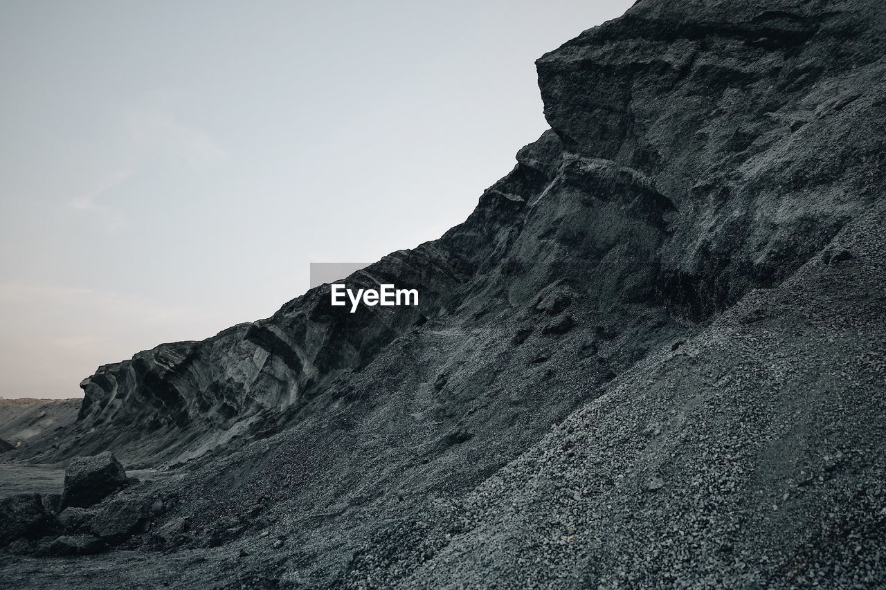 LOW ANGLE VIEW OF ROCK FORMATION AGAINST SKY