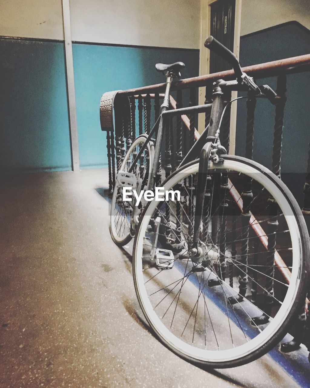 Bicycle parked by railing