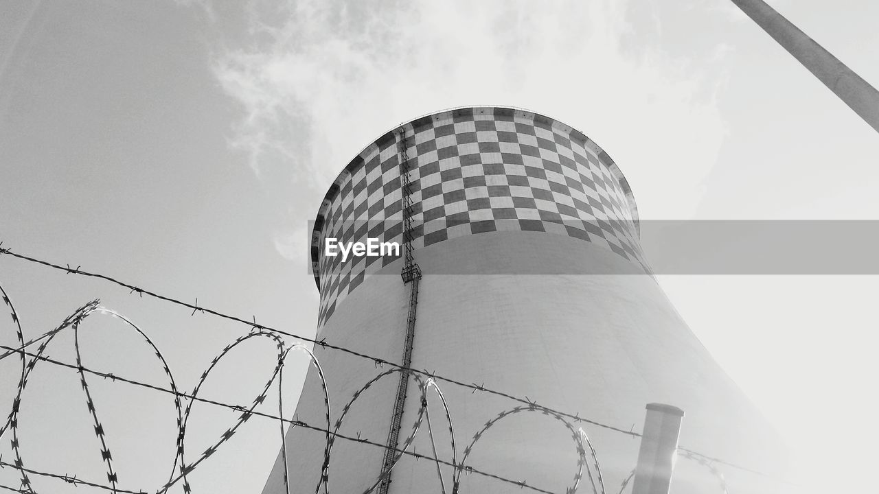 Low angle view of cooling tower against sky