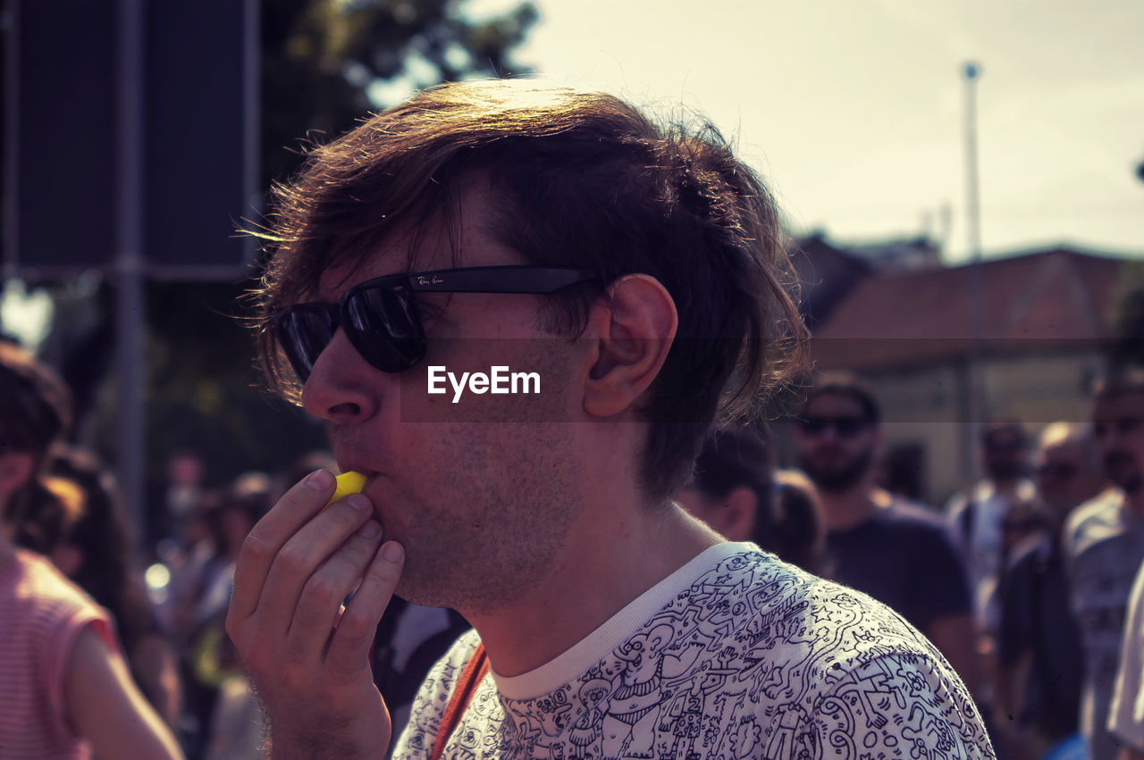 PORTRAIT OF YOUNG MAN WITH SUNGLASSES