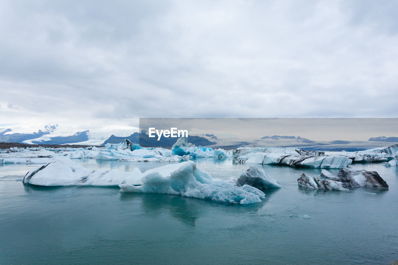 FROZEN LAKE AGAINST SKY