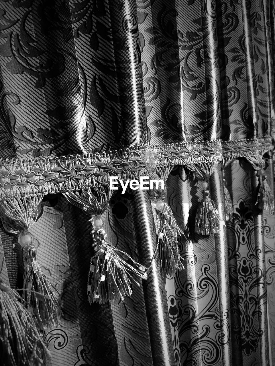 CLOSE-UP OF ROPES HANGING ON WALL