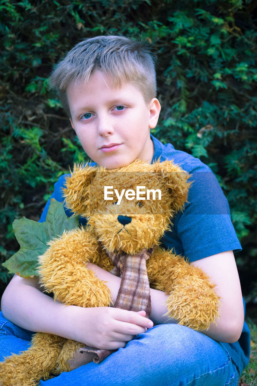 Portrait of boy holding toy