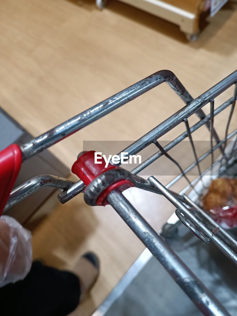 hand, indoors, metal, close-up, food and drink, wheel, bicycle, business, focus on foreground, one person, holding