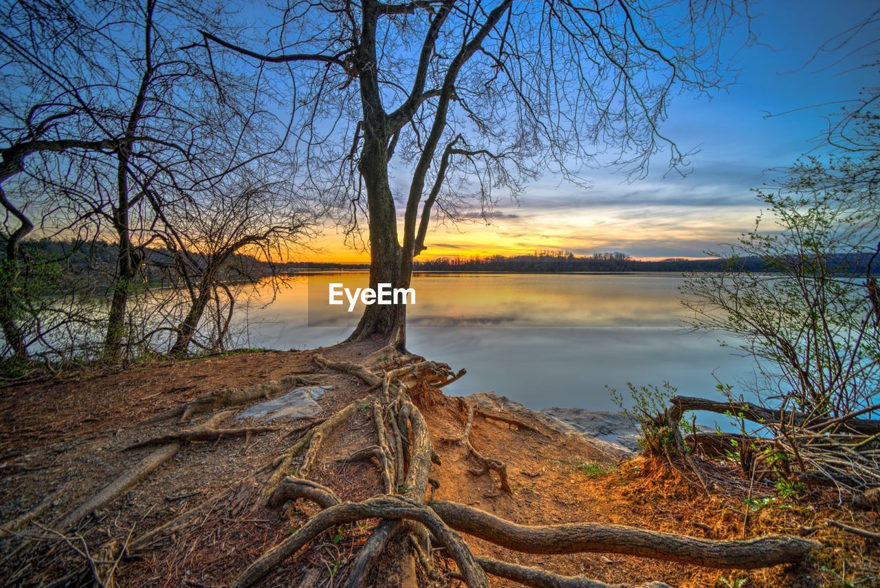 SCENIC VIEW OF LAKE AT SUNSET